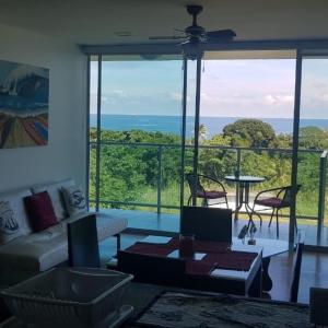 a living room with a view of the ocean at Paraiso Caribeño 706 in Colón
