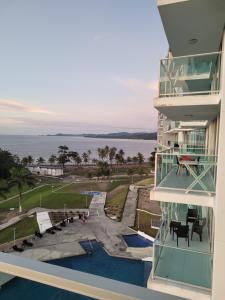 a balcony of a building with a view of the water at Paraiso Caribeño 706 in Colón +4 photos