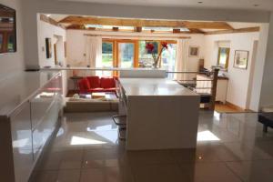 a kitchen with a white island in a room at Prestwick Oak - Sleeps 10 - Rural Oak Frame Barns in Chiddingfold