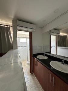 a bathroom with two sinks and a toilet at Casona La Española in Cartagena de Indias