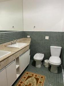 a bathroom with a toilet and a sink and a toilet at Condomínio Mata Azul in São Sebastião