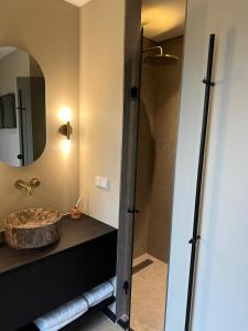 a bathroom with a sink and a shower at The Mini Villa in Alkmaar