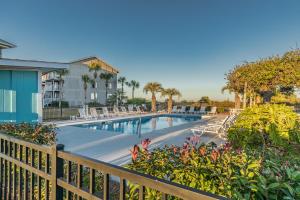 a swimming pool with chairs and a fence at New Listing - First floor condo on Harbor Island in Harbor Island