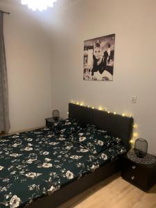 a bedroom with a bed with flowers on it at Apartament Second Home in Strzelce Opolskie