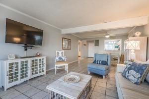 a living room with a couch and a tv at New Listing - First floor condo on Harbor Island in Harbor Island
