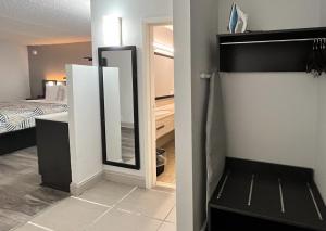 a bathroom with a mirror and a bedroom with a bed at Studio 6 Rock Hill, SC Cherry Road in Rock Hill +16 photos