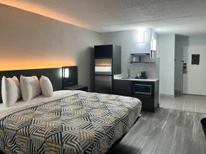 a hotel room with a bed and a kitchen at Studio 6 Rock Hill, SC Cherry Road in Rock Hill