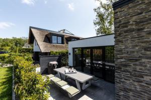 a backyard patio with a table and chairs at The Mini Villa in Alkmaar
