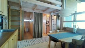 a kitchen and dining room with a table and a sink at Falkstigen 1 in Funäsdalen