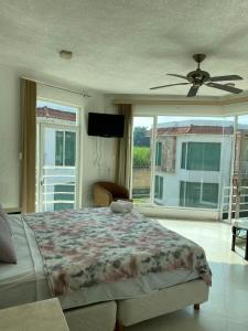 a bedroom with a bed and a ceiling fan at Finca 3G in Cocoyoc