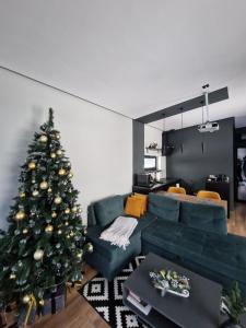 a living room with a christmas tree and a couch at Chilloutzonе - Будинок з безкоштовним джакузі та кінотеатром in Slavske