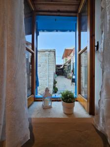an open door to a patio with a plant at Cozy Traditional 1 Bedroom Home Omodos Village in Omodos