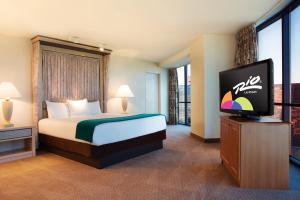 
a hotel room with a bed and a television at Rio All-Suite Hotel & Casino in Las Vegas
