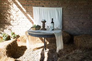 a table with a bottle of wine on top of it at Cabaña Amanecer - Finca la Falda - Salta in Cerrillos +6 photos