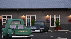 two old trucks parked in front of a building at Fireside Inn in Long Beach