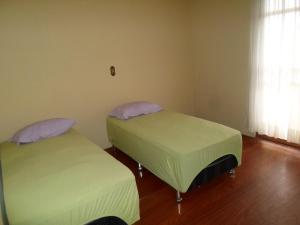 Ένα ή περισσότερα κρεβάτια σε δωμάτιο στο Assel Pousada Xaxim