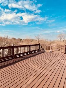 a wooden boardwalk with a wooden fence and trees at That 70s House at Hidden Creek Estates in Roscoe