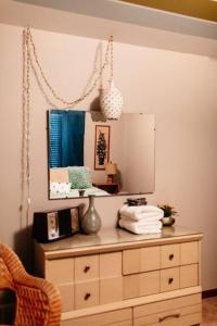 a room with a dresser and a mirror on the wall at That 70s House at Hidden Creek Estates in Roscoe