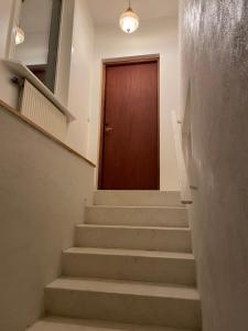 a stairway with a brown door and a brown door at Villa Room in Malmö