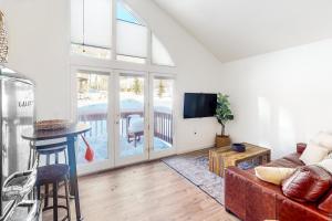 a living room with a couch and a table at Away Out on the Mountain in Crested Butte