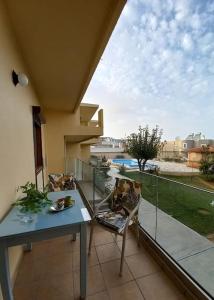 a balcony with a table and chairs and a view at Kalliopi Apt in Kavros