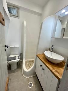 a bathroom with a sink and a toilet at Aleria Central Apartment 2 in Naxos Chora