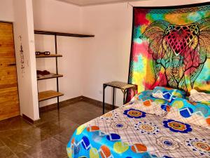 a bedroom with a bed with a colorful quilt at Sunset View, Taganga in Taganga
