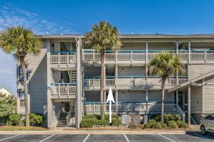 a building with palm trees in front of it at Direct Ocean View! M Building Pool and Ocean Views in Harbor Island