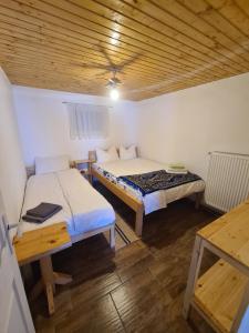 a small room with two beds and a table at Cabana Dor de Apuseni in Cîmpeni