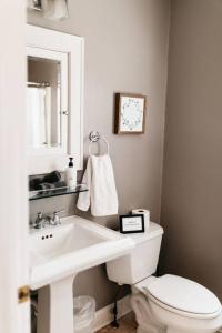 a bathroom with a white sink and a toilet at Cottage with Pond at Hidden Creek Estates in Roscoe