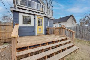 a house with a wooden deck with a yellow door at Colorado Springs Home Balcony with Mountain Views! in Colorado Springs