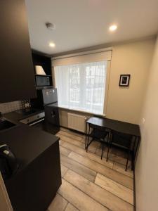 a kitchen with a table and chairs in a room at Valmiera City Centre Apartment in Valmiera