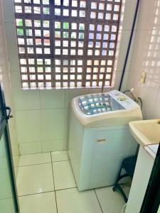 a small bathroom with a toilet and a window at RAVENA 11 in Ribeirão Preto