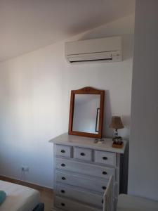 a dresser with a mirror on top of it at Appartement Penthouse II 15 - 5 in Mijas Costa