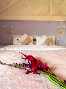 a bed with a bunch of flowers on it at Na Pagorbi Lutsk in Luts'k