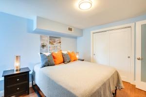 a bedroom with a bed with orange and blue pillows at Bikeable Apartment - 2 Mi to Downtown Oakland! in Oakland
