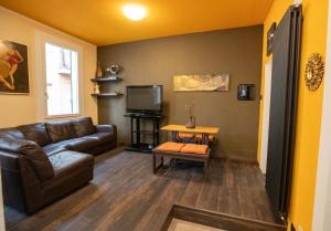 a living room with a couch and a tv at La Casa di Hank - il Centro Storico e l Autodromo in Imola +29 photos