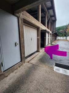 an empty building with a pink arrow painted on the ground at Trois Merlettes in Schiltigheim +10 photos