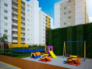 a playground with a slide and a swing set at Apto Brilho do Sol - Barra Velha - SC in Barra Velha