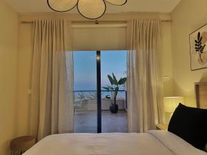 a bedroom with a bed and a view of the ocean at AURA MAR Mojácar Apartment in Mojácar +75 photos