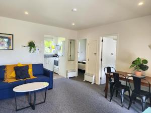 a living room with a blue couch and a table at U Studios Masterton in Masterton +46 photos