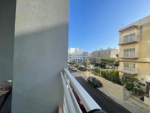 a view of a city street from a balcony at Great location accommodation in St Paul's Bay