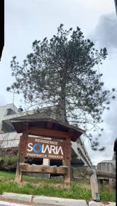 a sign with a tree in the background at Bilocale a Mazzin in Campestrin