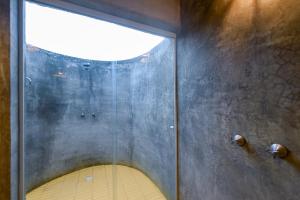 a bathroom with a large window in a room at Fazenda Poço das Pedras in São João do Cariri