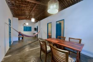 a dining room with a wooden table and chairs at Fazenda Poço das Pedras in São João do Cariri