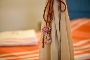 a curtain with a flower decoration on a bed at Fazenda Poço das Pedras in São João do Cariri