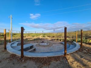 a fire pit in the middle of a field at Fazenda Poço das Pedras in São João do Cariri