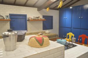 a kitchen with blue cabinets and a counter top at Fazenda Poço das Pedras in São João do Cariri