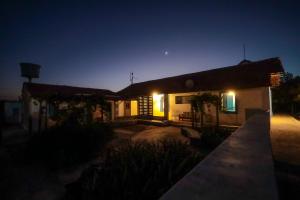 a small house at night with the lights on at Fazenda Poço das Pedras in São João do Cariri