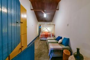 a room with a couch and a bed in it at Fazenda Poço das Pedras in São João do Cariri